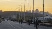 Люди пешком переходят мост после атаки РФ