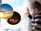 Дитина дивиться на сніг за вікном