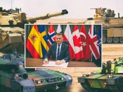 Министр обороны Польши Мариуш Блащак провел переговоры о танках на фоне флагов стран-союзников