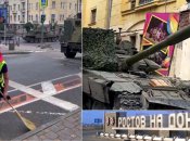 Двірник обмітає солдатів та танк в воротах цирку