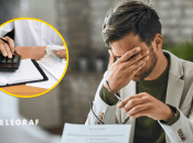 Калькулятор та чоловік, що закрив обличчя рукою