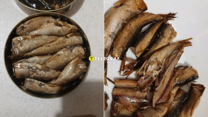 Банка со шпротами и рыба, переложенная на белую тарелку