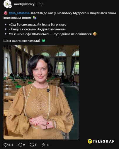Женщина в бежевом платье стоит в библиотеке с книжными стеллажами