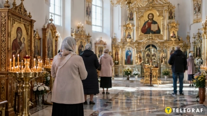Верующие стоят перед иконами в православном храме