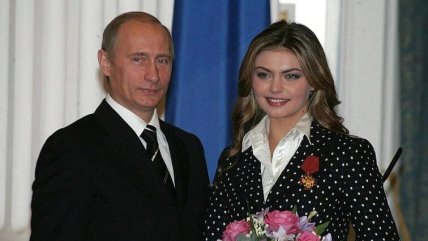 Владимир Путин и Алина Кабаева стоят рядом с букетом цветов