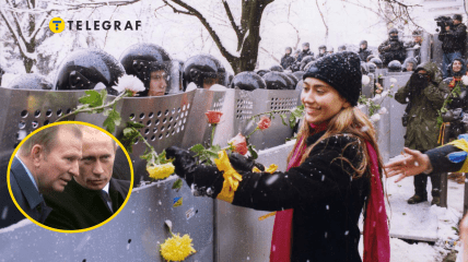 Девушка в Киеве украшает розами щиты сотрудников милиции во время Оранжевой революции