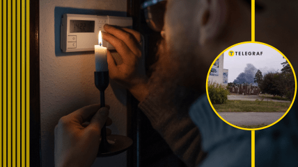 Чоловік зі свічкою біля лічильника електроенергії