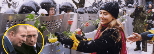 Девушка в Киеве украшает розами щиты сотрудников милиции во время Оранжевой революции