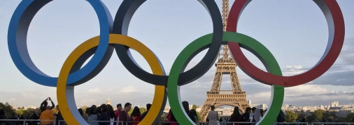 Олимпийские кольца на фоне Эйфелевой башни