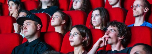 Люди смотрят фильм в кинотеатре